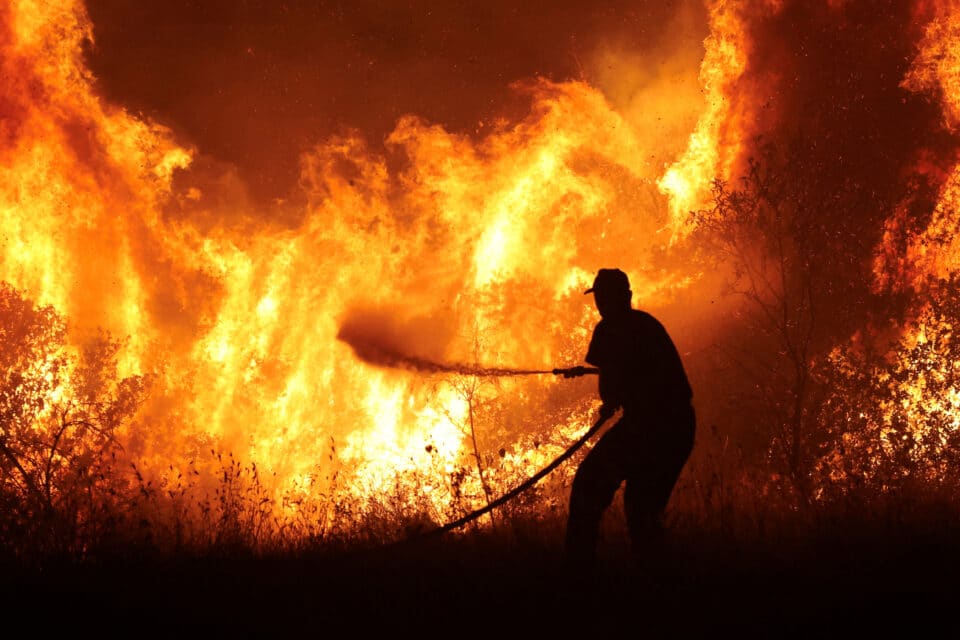 Wildfire burning at the industrial zone of the city of Volos, in central Greece, July 26, 2023. REUTERS/Alexandros Avramidis   