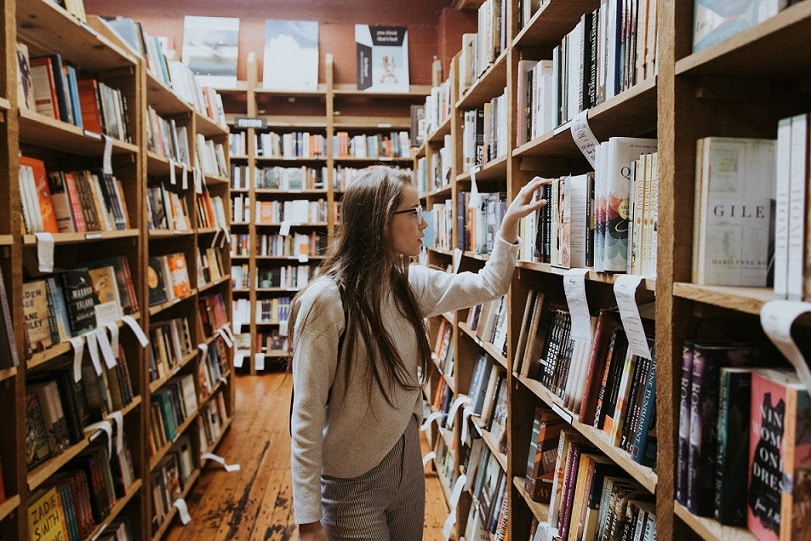 University student choosing a book from the library