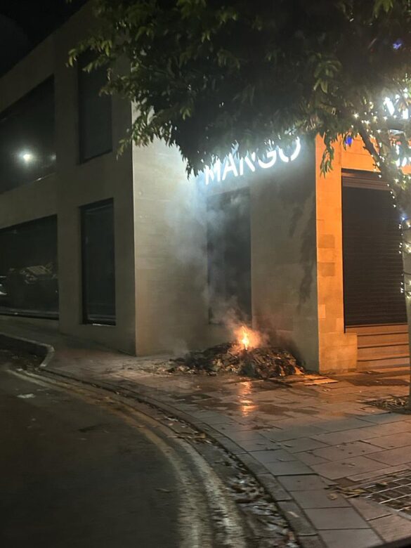 A fire dying down outside of Mango store on Anexartisias