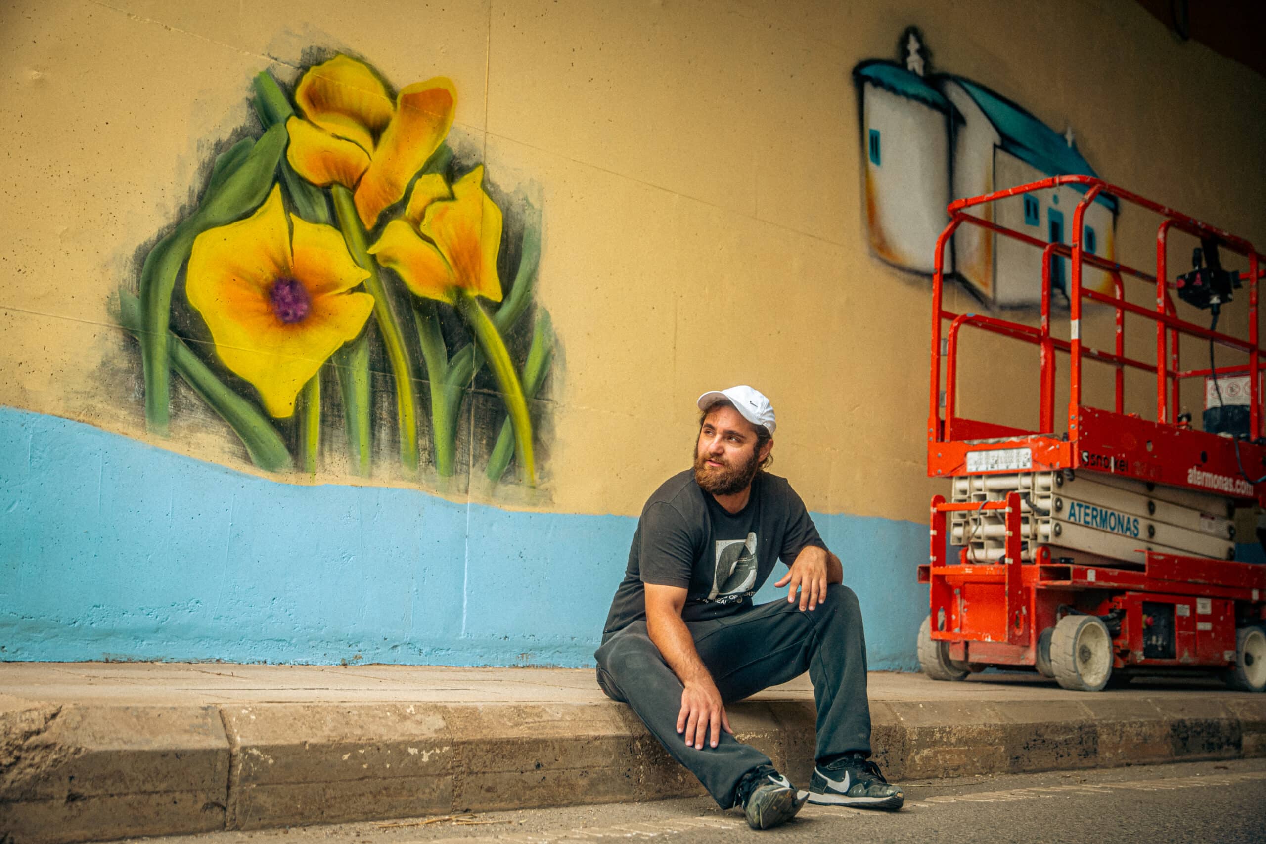 feature melissa rafael stavrinou takes a break from working on his mural